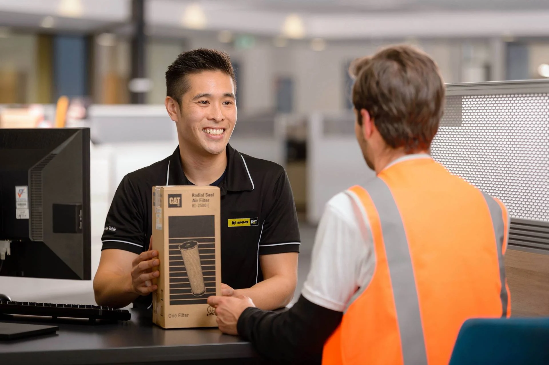 A Wagner parts advisor helping a customer at the counter